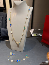 Shop the Lucky Spring motif necklace featuring luminous MOP blossoms, a vibrant blue lapis lazuli butterfly, and malachite leaves set in a gold chain. Elegant nature-inspired design perfect for luxury everyday wear or special occasion gifting.